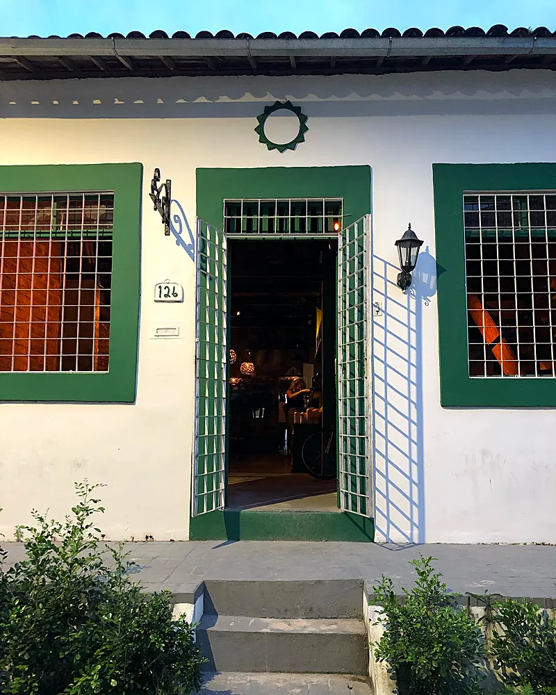 Fachada da casinha do Pitaco no Poço da Panela, com portas e janelas verdes